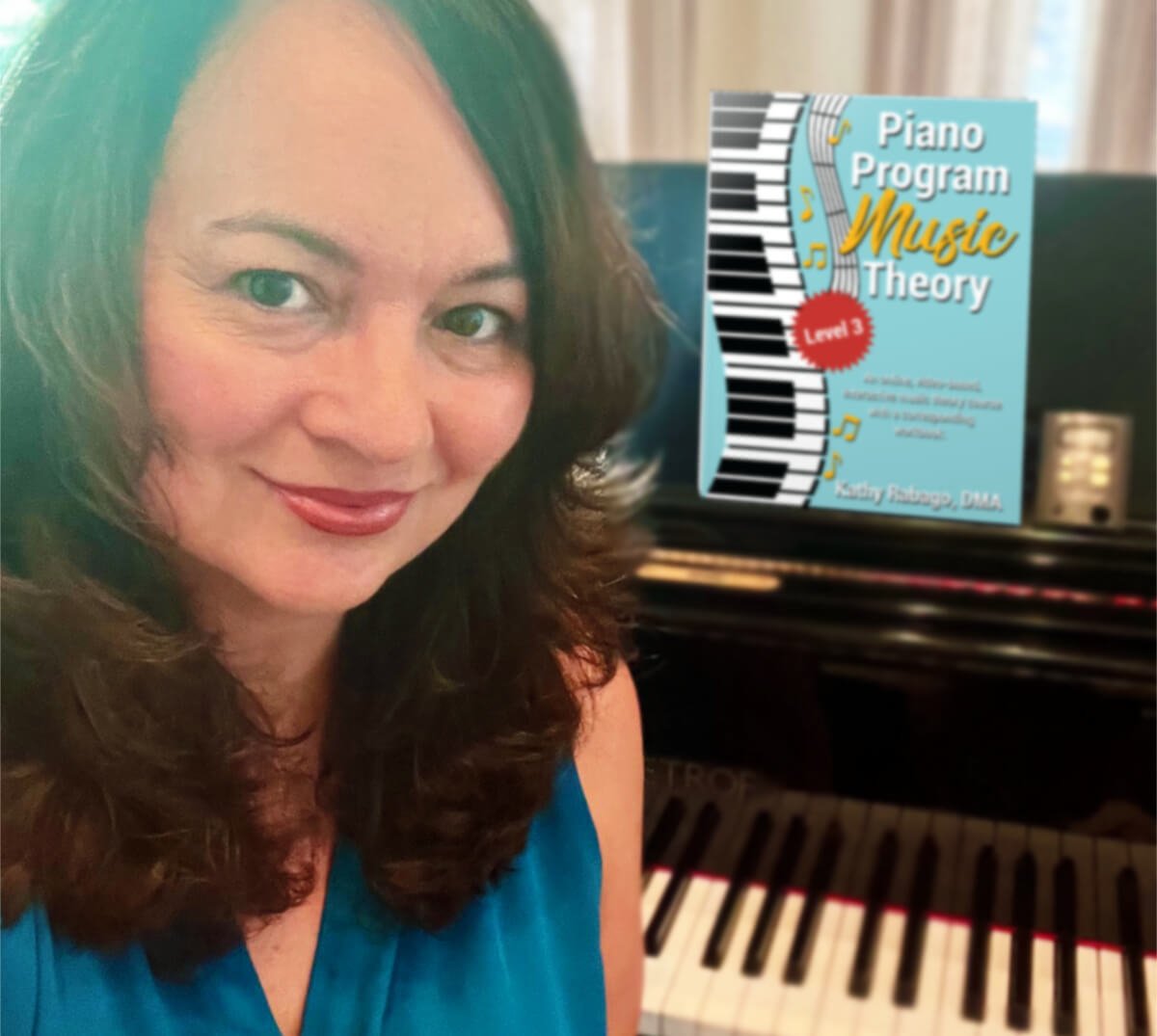 Head and shoulder portrait of a softly smiling woman with shoulder-length brown hair wearing a blue sleeveless top, with a piano in the background holding a Piano Program music Theory Book on the music stand